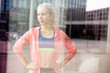 © Tandem Stock - European Quarter, Stuttgart, Baden-W¸rttemberg, Germany: Portrait of a female runner in an urban environment. Shot through the glass walls of an office building.