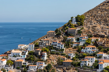 Wall Mural - Houses and buildings in the mountains with trees and vegetation in Hydra Island