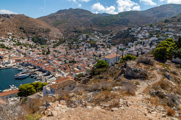 Wall Mural - City view with buildings and boats in the pier in Hydra Island