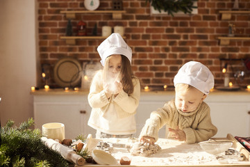 Happy family funny kids are preparing the dough, playing with flour in the kitchen