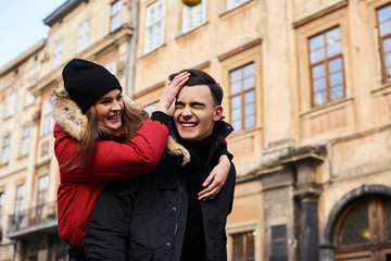 A trendy young couple walks in the city at christmastime