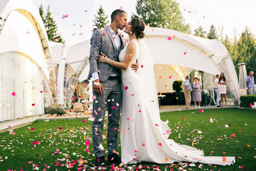 young couple in love.Wedding photo.Rose petals over a couple in love