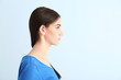 © Pixel-Shot - Young woman with hearing aid on color background