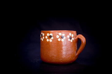 cup traditional clay mexican hand painted with floral pattern on black background