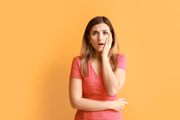 Sticker - Portrait of worried young woman on color background