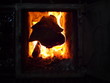 A burning log in a fireplace keeping the room warm