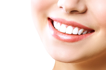 Stomatology concept. Partial portrait of a girl with white teeth smiling. Closeup of young woman at dentist's, studio, indoors. isolated on white background.