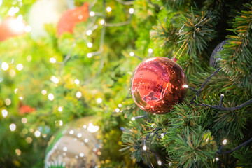 Gold Christmas background of de-focused lights with decorated tree