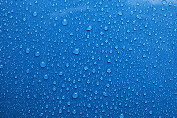water drops on blue background, top view