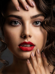 Poster - Face of a beautiful woman with a smoky eye makeup and red lipstick