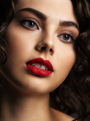 Poster - Face of a beautiful woman with a smoky eye makeup and red lipstick