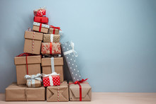 Pile Of Wrapped Christmas Gifts On Blue Background