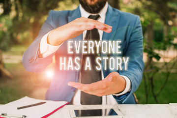 Poster - Conceptual hand writing showing Everyone Has A Story. Concept meaning Background storytelling telling your memories tales Man in front of table. Mobile phone and notes on the table