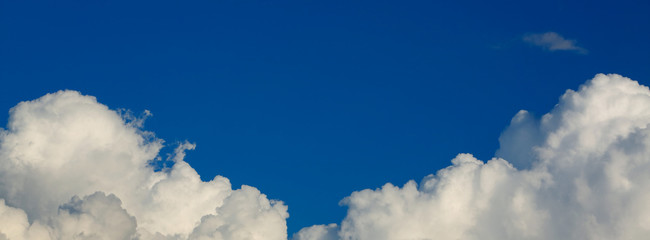 panorama image, fluffy white cloud above clear blue sky background