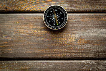 Wall Mural - Compass - small and stylish - on dark wooden background top view copy space