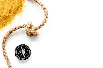 Wall Mural - Goal achievement concept. Compass near rope with knot on white background top view copy space
