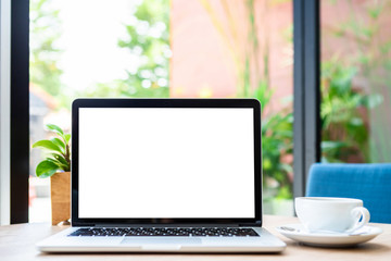 Mockup of laptop computer with empty screen with coffee cup on table of the coffee shop background,White screen
