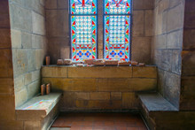 Niche With A Stained Glass Window And Two Stone Benches In An Old Castle