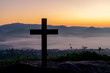 cross crucifixion of the crucifixion of jesus christ on a mountain with a morning sky background