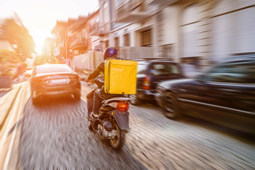 Fast and free delivery food by scooter in the afternoon in the city