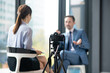 © zinkevych - Camera filming businessman giving interview to famous journalist