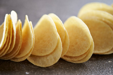 Potato chips on stone table 