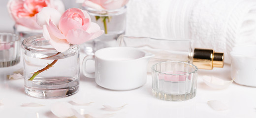 Wall Mural - Spa sitting with pink rose ,salt, candles, towel, petals in white background.