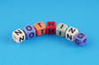 © mohdizuan - A word NOTHING made by a colourful cube beads alphabet  over blue background.