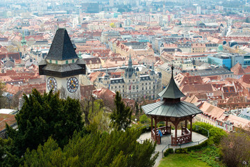 View at Graz City from Schlossberg hill, City rooftops, Mur river and city center, clock tower.