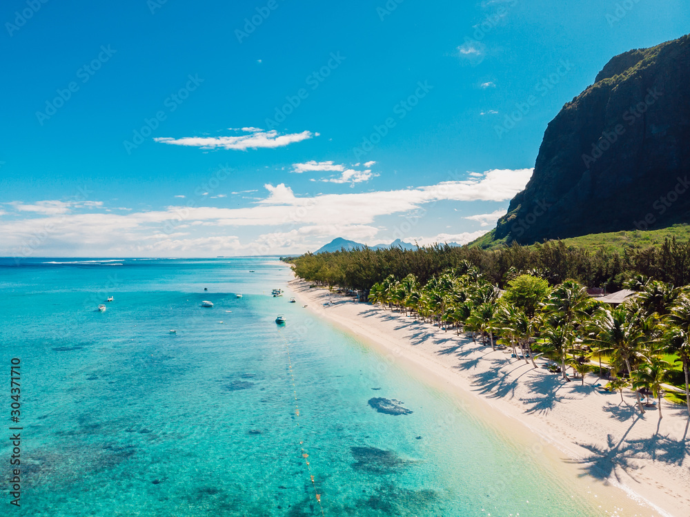 Luxury beach with mountain in Mauritius. Sandy beach with palms and ocean. Aerial view - obrazy, fototapety, plakaty 