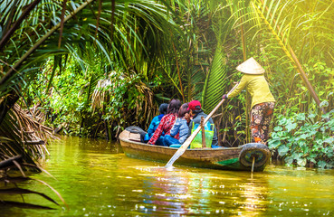 Wall Mural - tourist enjoying mekong delta cruise with canoe on vietnam