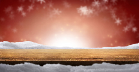 Wall Mural - A Christmas tabletop product display background with snow and blurred red bokeh.