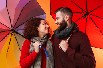 Canvas Print - Happy young loving couple with umbrella.