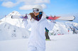 © ZoomTeam - Portrait of beautiful woman with ski and ski suit in winter mountain.