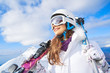 © ZoomTeam - Portrait of beautiful woman with ski and ski suit in winter mountain.