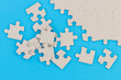© Oleksandr - Unfinished white jigsaw puzzle pieces on blue background
