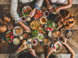 © sonyakamoz - Turkish breakfast. Flat-lay of Turkish family eating traditional pastries, vegetables, greens, cheeses, fried eggs, jams and tea in copper pot and tulip glasses over rustic wooden background, top view