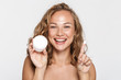 © Drobot Dean - Image of cheerful half-naked woman showing facial cream and smiling