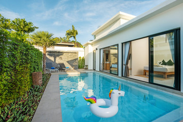 Swiming pool in luxury pool villa with floating unicorn