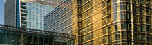 Modern City Building Architecture With Glass Fronts On A Clear Day At Sunset In London, England Panoramic