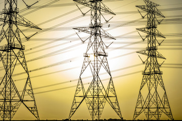 Wall Mural - installation of a new electricity supply poles without it's cables in the middle of desert in Saudi Arabia  