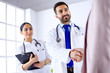 © khmelev - Young arab doctor shakes hands with a patient in a hospital