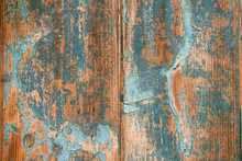 Texture Of An Old Wooden Door With Blue Peeling Paint. The Combination Of Orange, Blue, Azure And Sand Shades