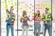 © moodboard - Creative business people discussing, organizing, analyzing plans through adhesive notes in office