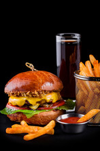 Cheeseburger With Fries And Sauce On A Black Background