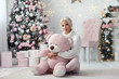 Young beautiful girl with pink bear
