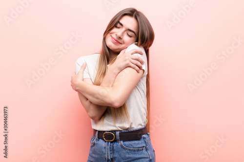 Cuadros en Lienzo young pretty woman feeling in love, smiling, cuddling and hugging self, staying