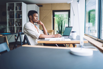 Sticker - Pensive black man working at table in office