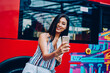 Attractive female tourist making selfie on smartphone standing on sightseeing buss background,happy asian woman enjoying city tour making photo on mobile for share with followers on travel blog