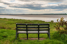 A Bench At The Solway Coast, Looking At The Channel Of River Esk In Bowness-on-Solway, Cumbria, England, UK